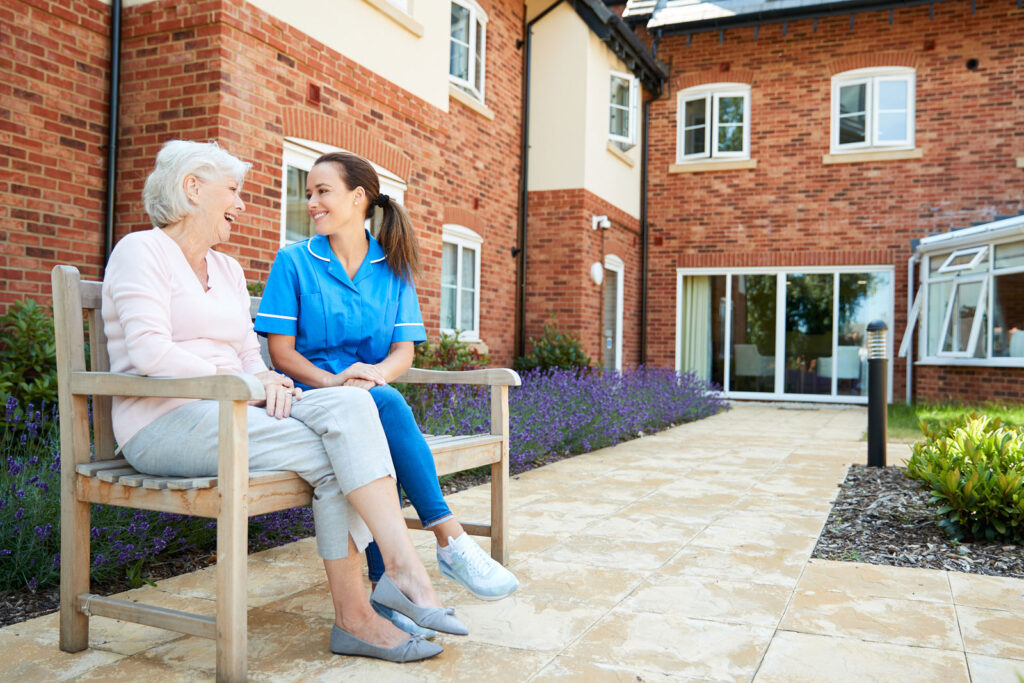 bigstock-senior-woman-sitting-on-bench-258166300-mulberry-live-in
